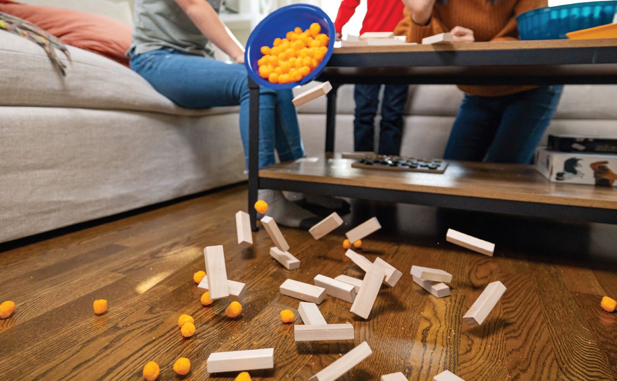 Family Game Night with toys on a hardwood floor.