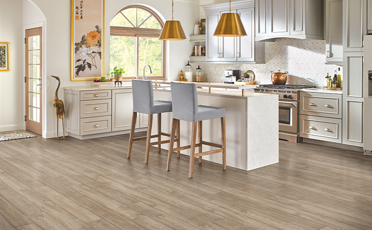luxury vinyl plank kitchen with grey chairs and island
